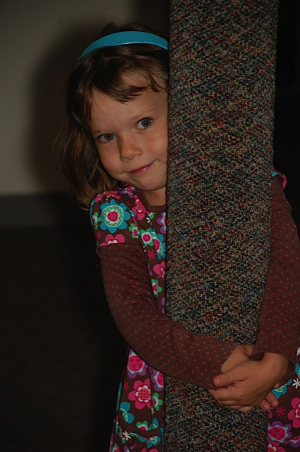 Young Girl Hugging Post